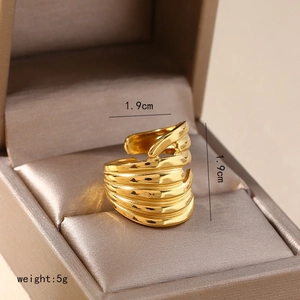 Macro detail of irregular gold layered ring showing size parameters in jewelry box