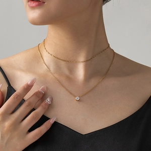 Double-layered gold titanium steel necklace featuring a single round zircon solitaire pendant