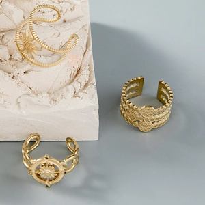 Three-piece gold plated stainless steel ring set with sunburst and starburst designs