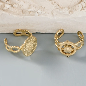 Detail of vintage gold-plated ring set with textured relief and hollow chain design