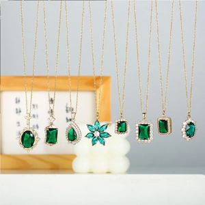 French vintage gold necklaces collection with emerald green gemstones in various shapes