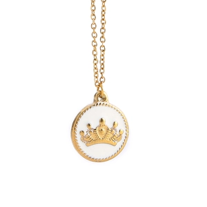 Macro shot of gold crown relief necklace pendant with white enamel and twisted edges