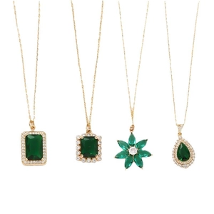 Vintage emerald green pendant necklaces with gold finish and zircon stones on white background