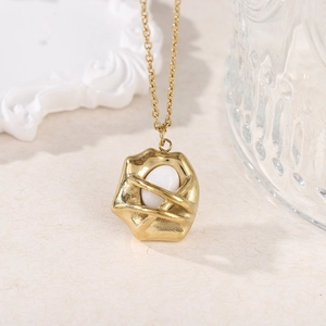Detailed close-up of 18k gold-plated hammered pendant with white stone inlay on chain