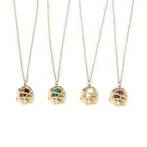Detail of four 18k gold plated titanium necklaces with malachite and tiger eye stones