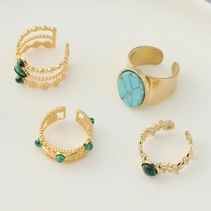 Ensemble de quatre bagues vintage en acier doré avec œil de tigre et turquoise