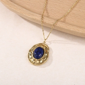 Détail du pendentif en pierre naturelle bleue avec texture martelée dorée polie