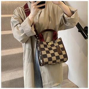 Checkerboard tote bag with striped wide shoulder strap and metal twist lock detail