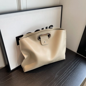 Minimalist cream leather handbag with metal oval handle and large capacity design