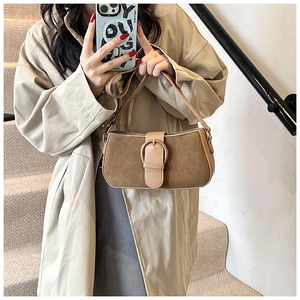 Detail showing the brown suede and PU leather texture with a gold ring buckle on bag