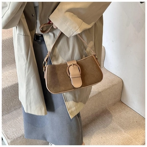 Close-up of coffee brown suede and leather hobo bag with gold metal buckle detail