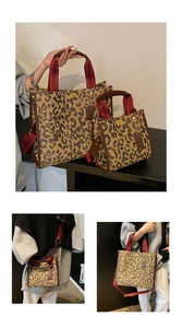 Detail view of leopard print tote bags with canvas texture and gold hardware accents