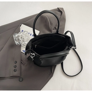 Internal view of the pleated bucket bag showing the lining and functional storage pockets