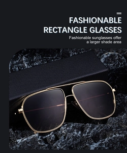 Detail view of square frame sunglasses with golden metal rims on premium black stone stand