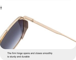 Macro view of sturdy metal hinge and golden frame on punk square sunglasses