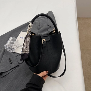 Classic black litchi texture leather bucket bag with geometric silk scarf decoration