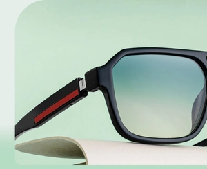 Detail of square sunglasses hinge with red stripe on temple and gradient lenses