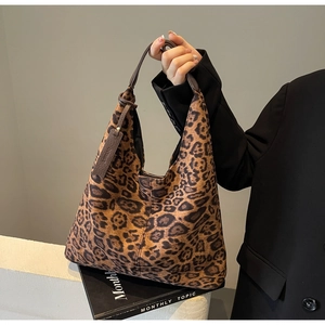 Close-up of leopard print hobo bag texture with premium brown leather strap detail