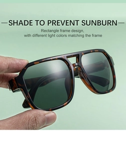 Detail view of square tortoiseshell sunglasses featuring deep green lenses and double bridge