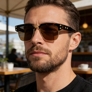 Detail of polarized square sunglasses with tortoise frame and gold metal accents on model