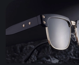 Macro shot of retro square sunglasses with gold metal bridge and rivet details