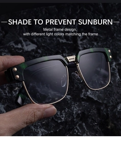 Close-up of retro square sunglasses featuring dark green marble frames and gold metal details