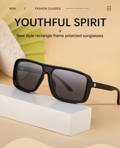 Detail of matte black rectangle polarized sunglasses on artistic stone and fan props