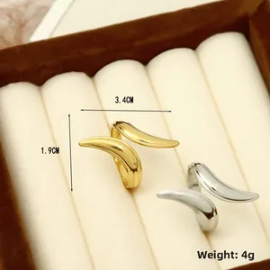 Macro shot showing dimensions and weight of gold and silver crossover curved rings