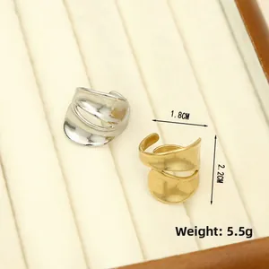 Detail of chunky gold and silver irregular textured rings with 1.8cm width dimensions