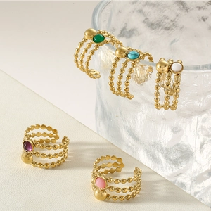 Detailed view of layered titanium steel rings featuring colorful natural stone beads
