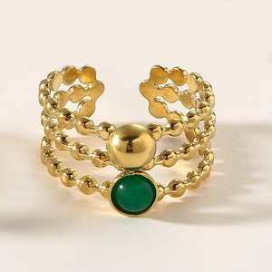 Detailed macro view of gold multi-layer beaded ring with a centered green natural stone