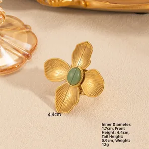 Detail of gold flower ring with green stone showing 4.4cm height and 1.7cm inner diameter
