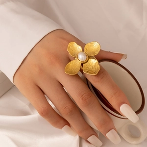 Gold stainless steel flower ring with central pearl and vintage brushed metal petals