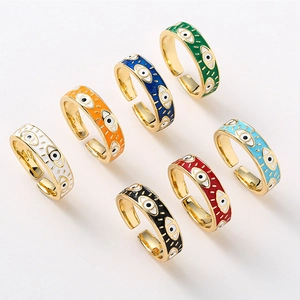 Detailed top view of seven colorful enamel evil eye open rings in bohemian style