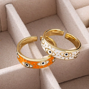 Detail of colorful enamel evil eye open rings in a soft velvet jewelry box