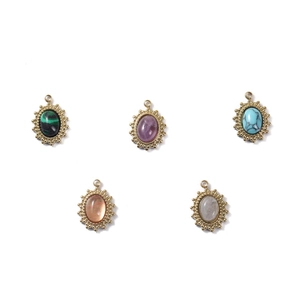 Five assorted sunburst oval gemstone charms with gold plating for jewelry making