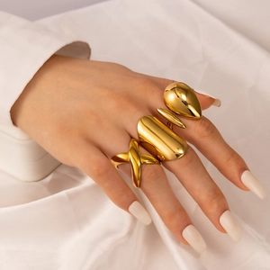 Detailed view of four bold 18k gold plated stainless steel rings on a hand