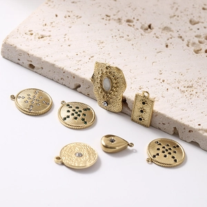 Detailed view of 14K gold plated stainless steel pendants with starburst zircon on stone