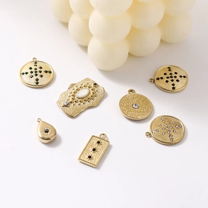 7-piece set of 14K gold plated stainless steel charms with moon and leaf designs