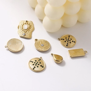 Macro shot of 14K gold plated stainless steel jewelry charms with inlaid rhinestones