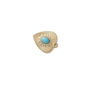 Detail of vintage heart pendant in gold finish with turquoise stone and radial texture