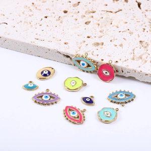 Detailed view of colorful evil eye pendants in gold stainless steel for jewelry making