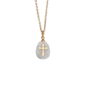 Macro detail of natural stone drop pendant with golden cross inlay and sleek metal chain