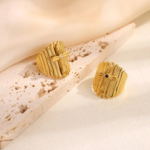 18k gold plated stainless steel cross rings with cubic zirconia on travertine stone
