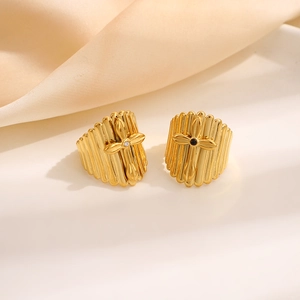 Vertical striped gold cross stud earrings with black and white zircon crystals