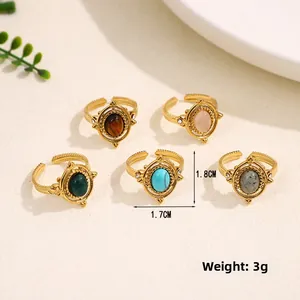Detailed view of five adjustable gold-plated vintage rings with natural stone inlays