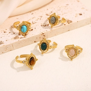 Detail of vintage palace style gold plated open rings with colorful natural stones and diamonds