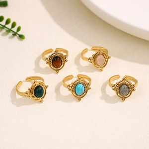 Set of five vintage gold adjustable rings featuring natural stones and diamond accents