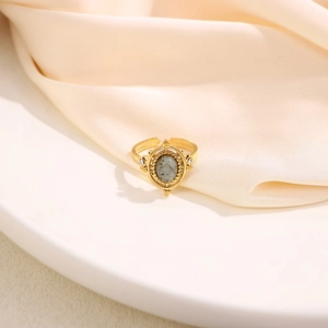 Vintage gold plated ring with oval natural stone and diamond accents on silk