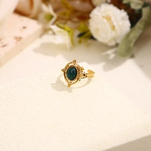 Vintage gold adjustable ring featuring a deep green oval stone with ornate carvings